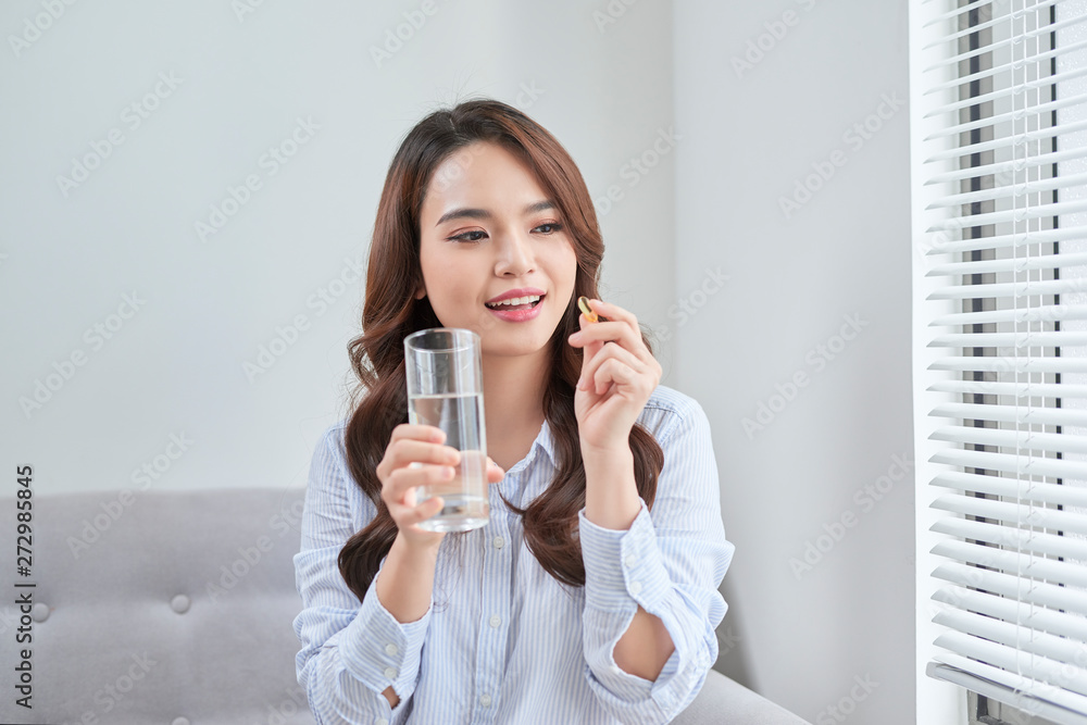 Beautiful Smiling Woman Taking Vitamin Pill. Dietary Supplement Beautiful Smiling Woman Taking Vitamin Pill. Dietary Supplement