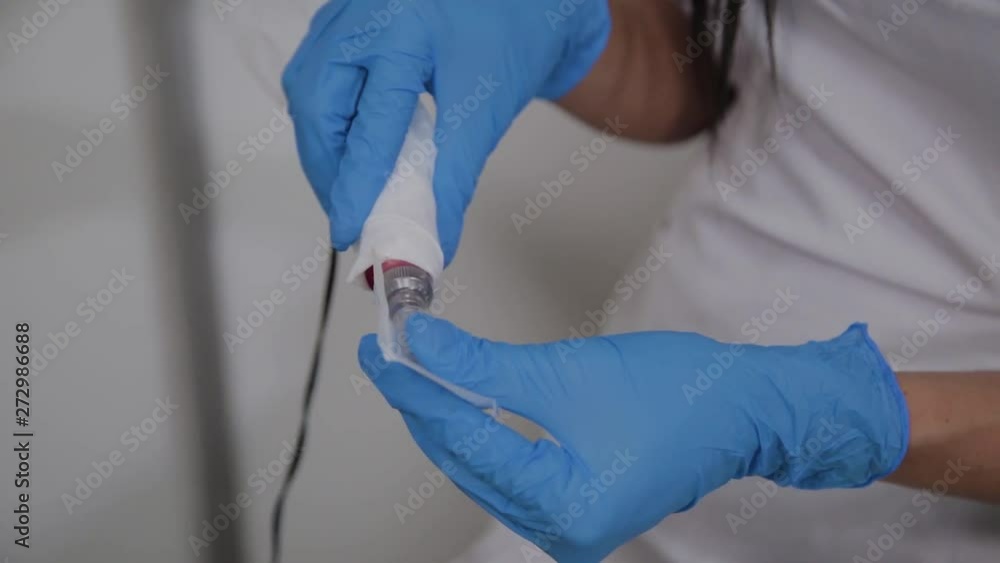 Professional cosmetologist puts needles on DermaPen apparatus. Professional cosmetologist puts needles on DermaPen apparatus.