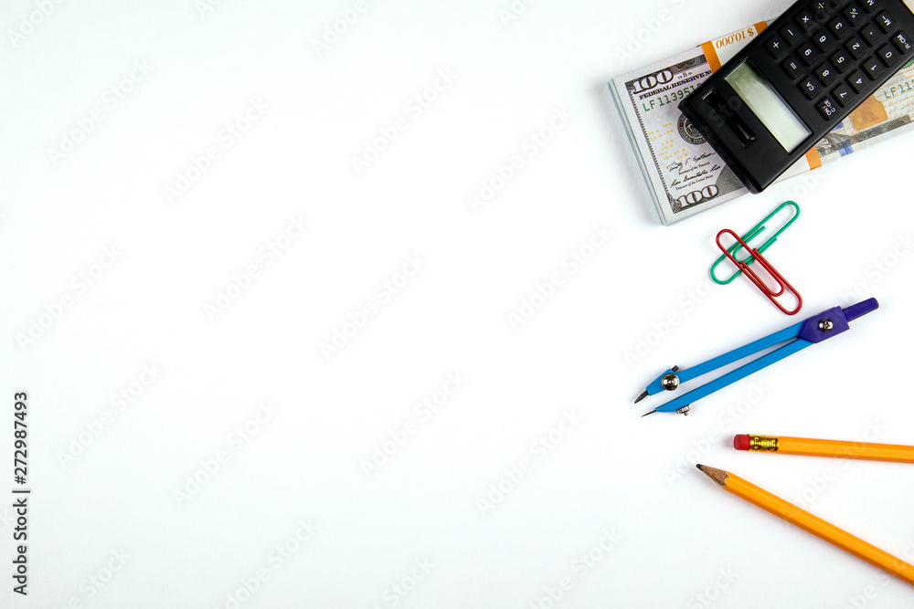 Minimal work space, flat lay photo of workspace desk. Top view office desk with pencil, circus and calculator, money on white color background. Banner background with copy space Minimal work space, flat lay photo of workspace desk. Top view office desk with pencil, circus and calculator, money on white color background. Banner background with copy space