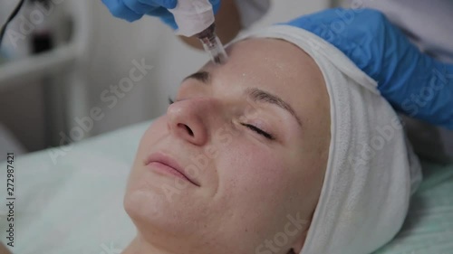 Professional cosmetologist performs DermaPen procedure in a cosmetology clinic. photo