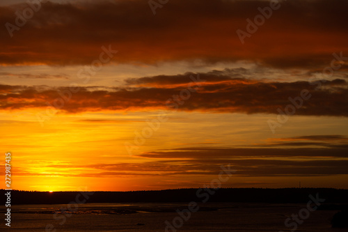 Tranquil sunset over the lake. The whole scene covered in golden colors. Concept of tranquility. Vacation landscape.