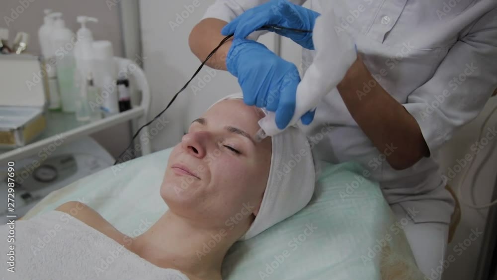 Professional cosmetologist performs DermaPen procedure in a cosmetology clinic. Professional cosmetologist performs DermaPen procedure in a cosmetology clinic.