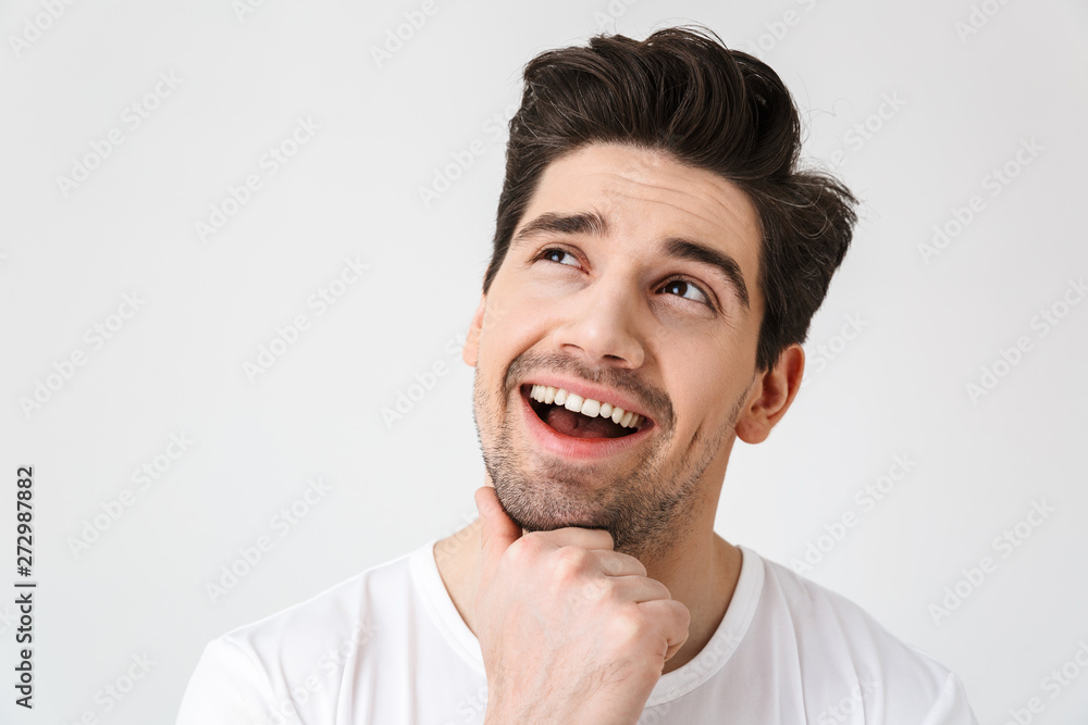 Happy young excited emotional man posing isolated over white wall background.