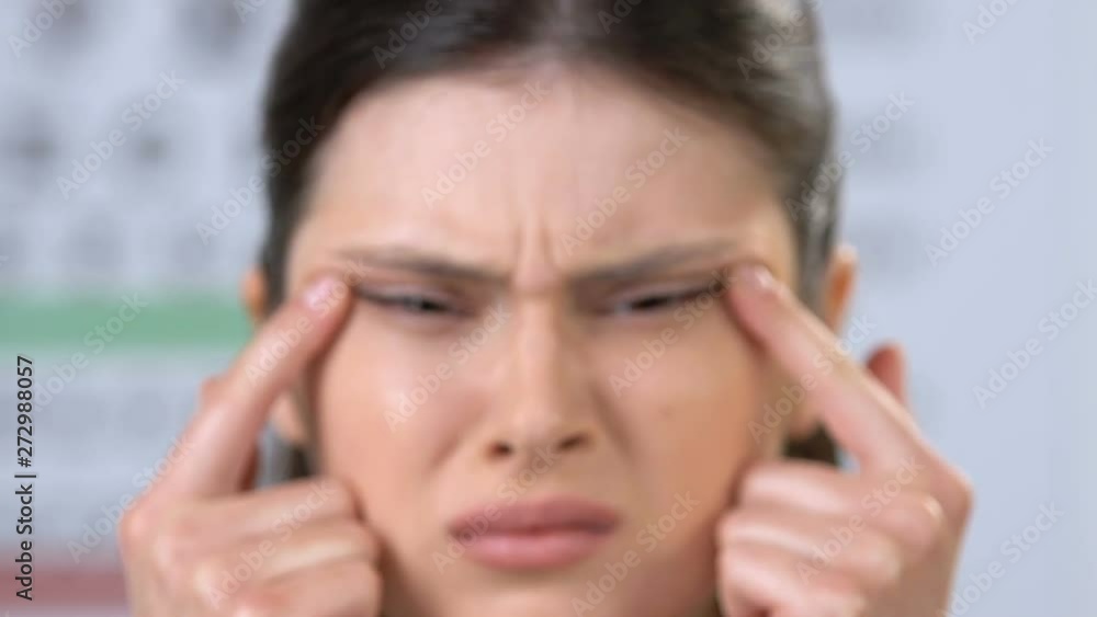 Woman stretching eyes with fingers, trying to focus, vision problems, blindness Woman stretching eyes with fingers, trying to focus, vision problems, blindness