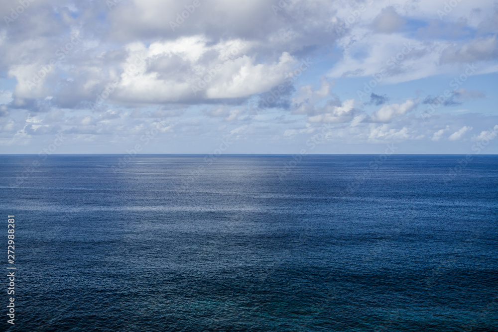 Obraz premium Atlantic ocean evening view , with horizon and white clouds background, Tenerife, Canary islands, Spain