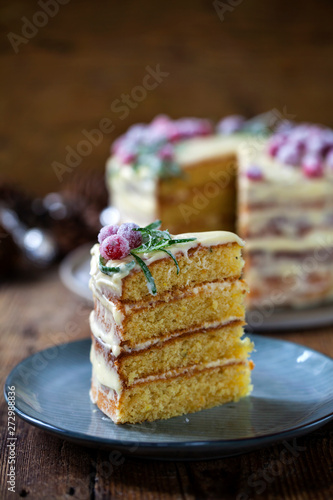 Layered Christmas cake with sugared cranberries and rosemary