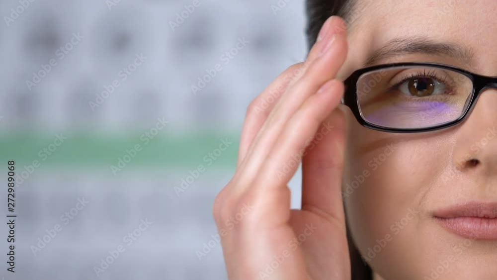 Smiling woman wearing eye glasses and looking at camera, ophthalmology clinic Smiling woman wearing eye glasses and looking at camera, ophthalmology clinic