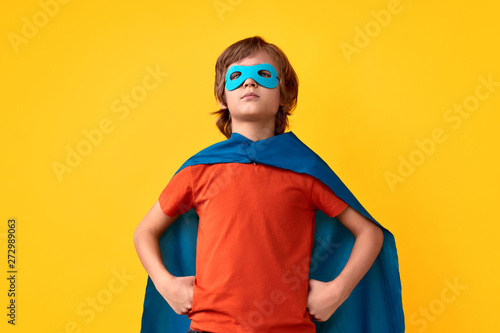 Confident little superhero in heroic pose