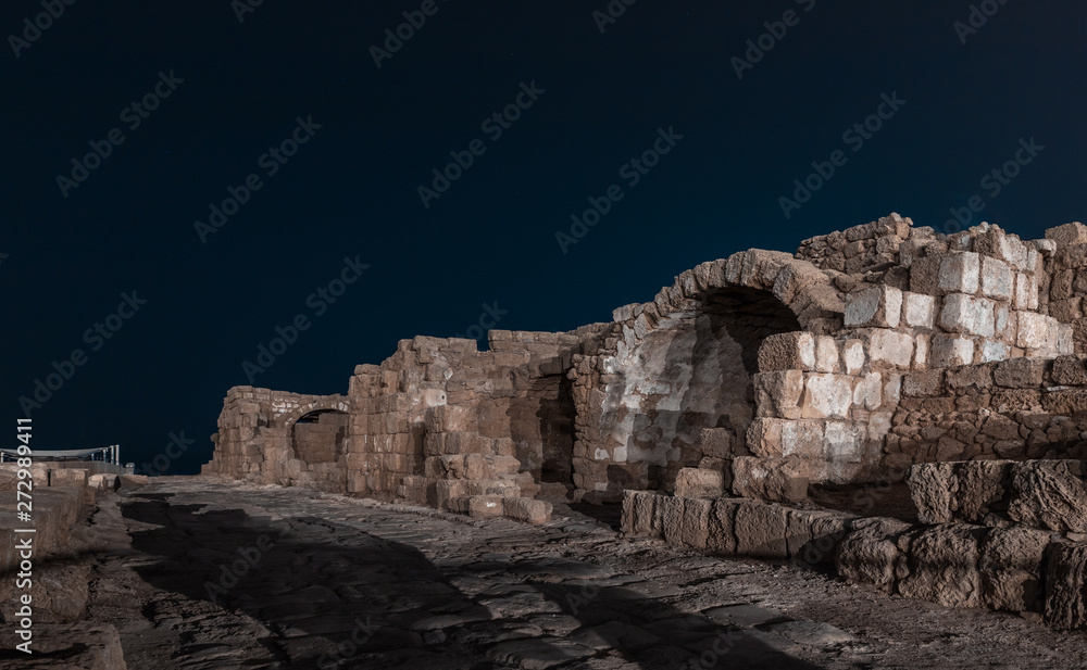 Fototapeta premium Night view of the ruins of Caesarea city on the Mediterranean coast, which was built by the king of Judea, Herod the Great, in honor of the Roman emperor Caesar Augustus
