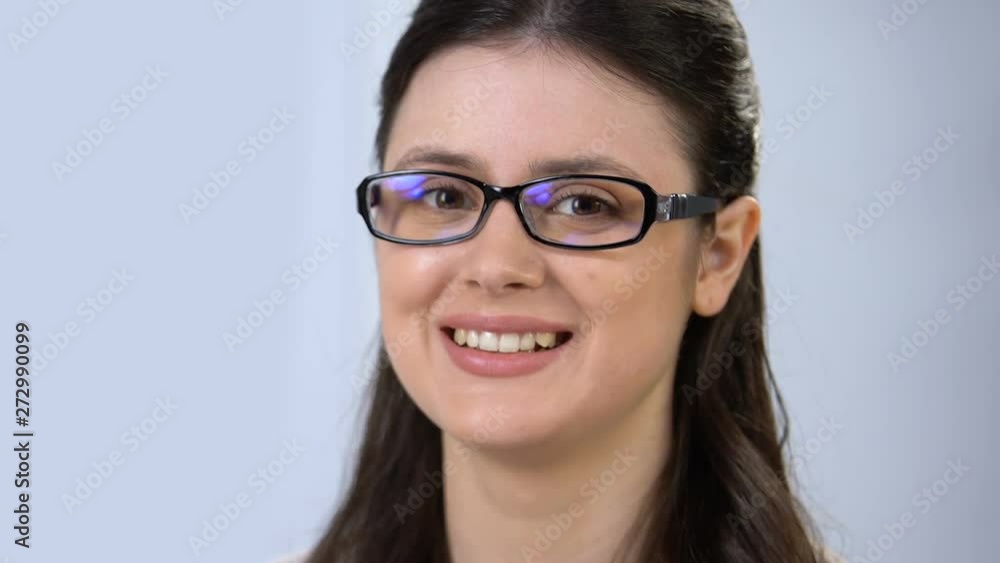 Woman fitting eye glasses and smiling at camera, vision support, health care Woman fitting eye glasses and smiling at camera, vision support, health care