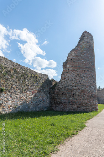 The remains of the fortress wall and the clock tower in the ruins of the Smederevo fortress, standing on the banks of the Danube River in Smederevo town in Serbia.