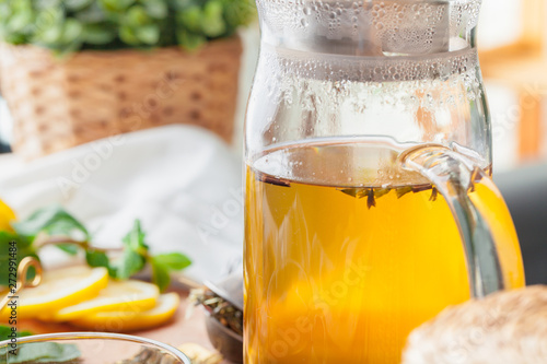 Tea pot of herbal tea on a wooden table close up