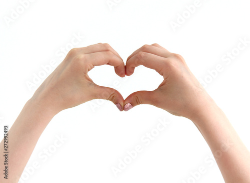 hands folded in the shape of a heart against a white wall