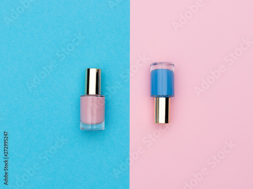 Flasks of pink and blue nail polishes photo