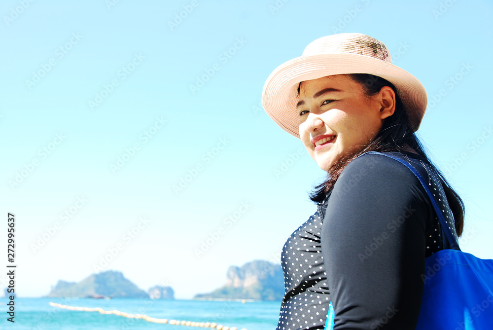 Beautiful Asia woman traveling beach in Thailand on summer holiday.