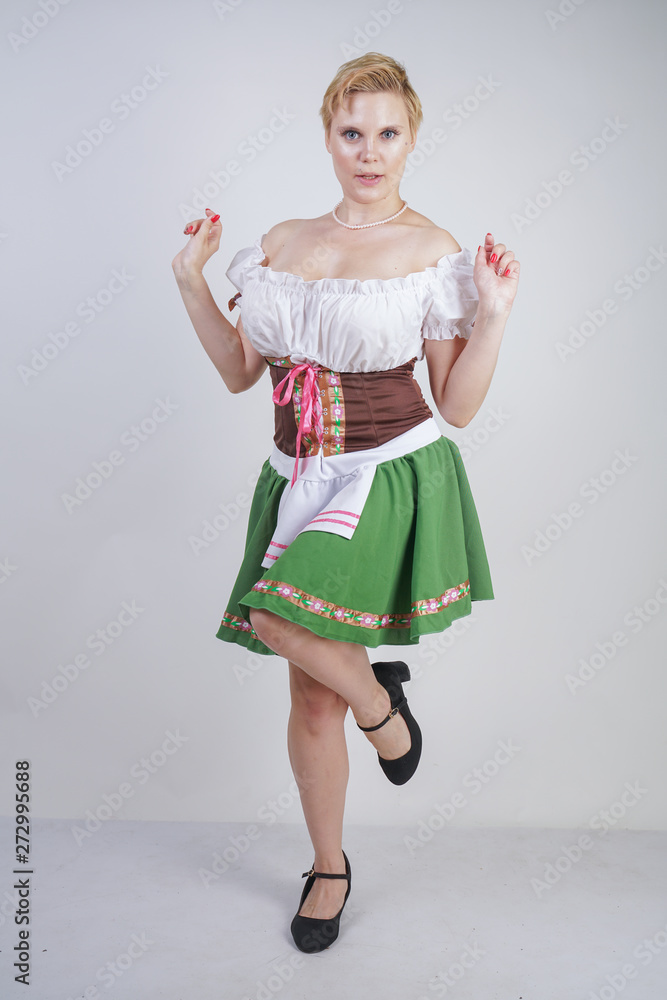 cute plus size girl with a short haircut and big Breasts dressed in a  national Bavarian