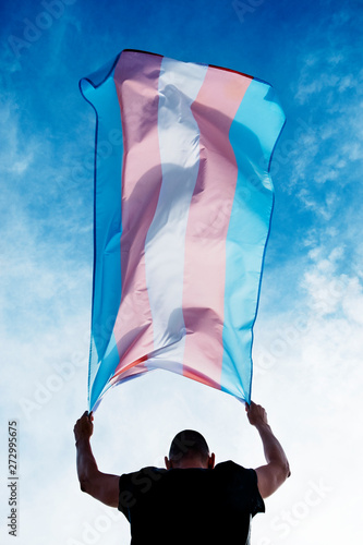 young person with a transgender pride flag photo