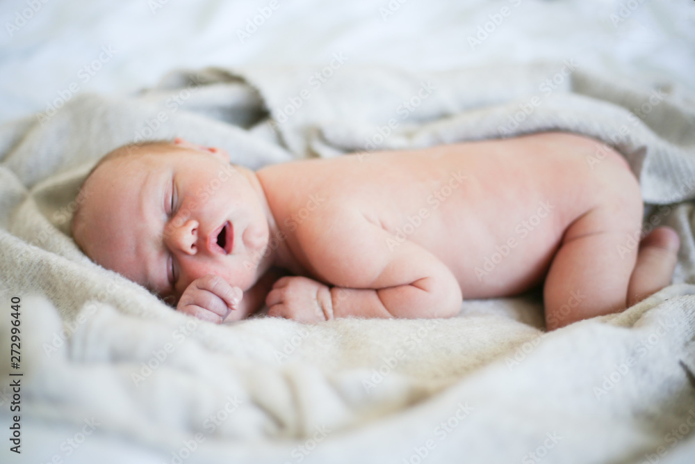 Newborn baby boy sleeping in children's cot - closeup Newborn baby boy sleeping in children's cot - closeup