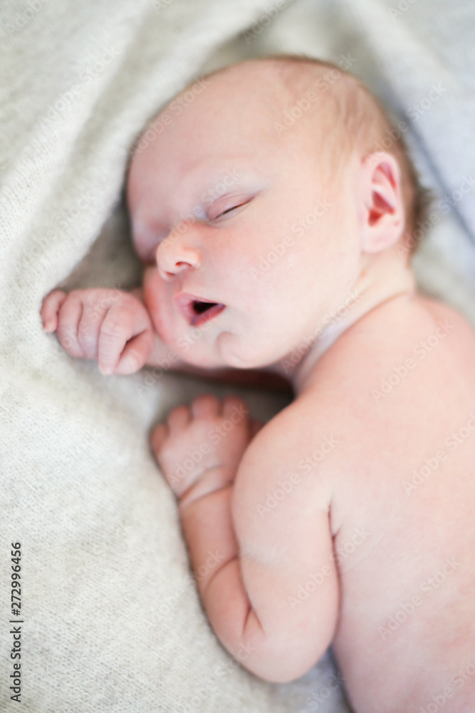 Newborn baby boy sleeping in children's cot - closeup Newborn baby boy sleeping in children's cot - closeup