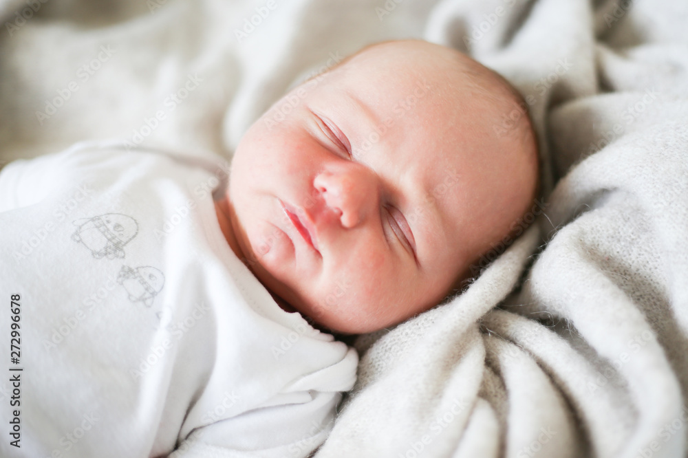 Newborn baby boy sleeping in children's cot - closeup Newborn baby boy sleeping in children's cot - closeup