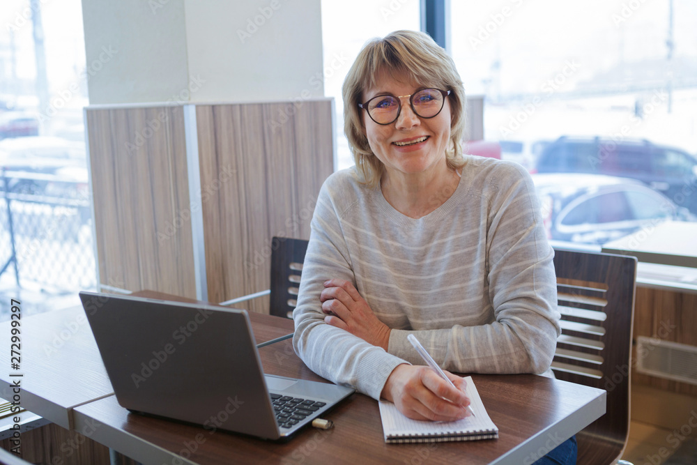 © Luca9257 - middle-aged woman business in workplace in cafe, office, she's working on her laptop. © Luca9257 - middle-aged woman business in workplace in cafe, office, she's working on her laptop.