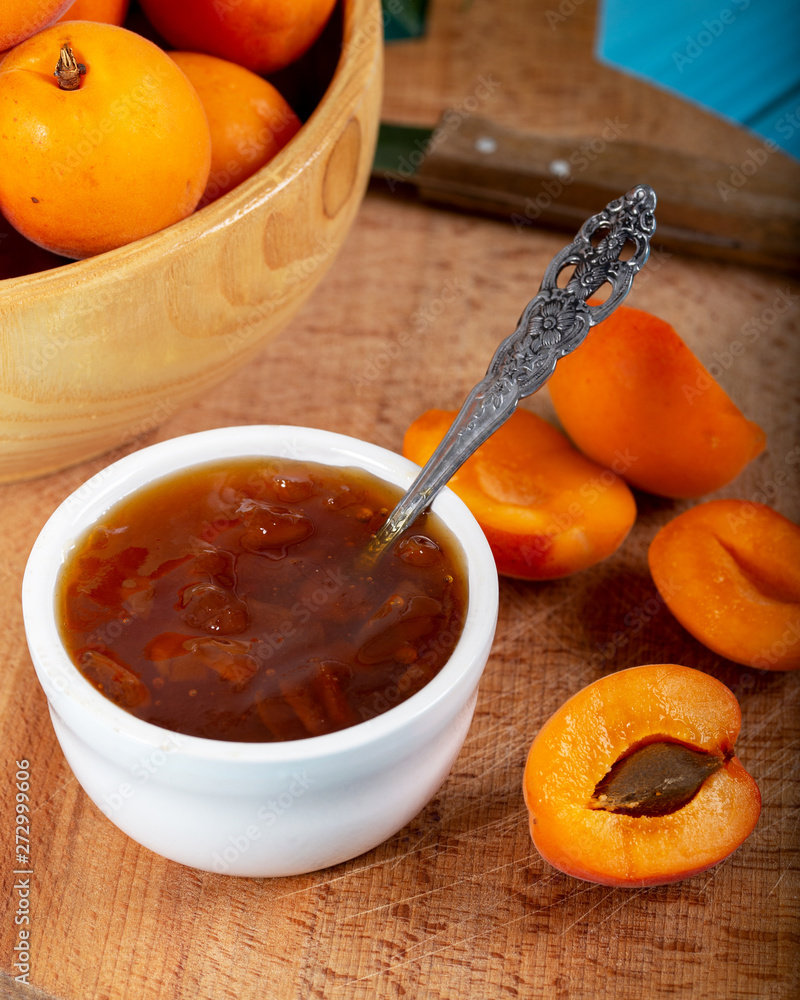 Apricot jam and fresh apricots in wood bowl. Apricot jam and fresh apricots in wood bowl.