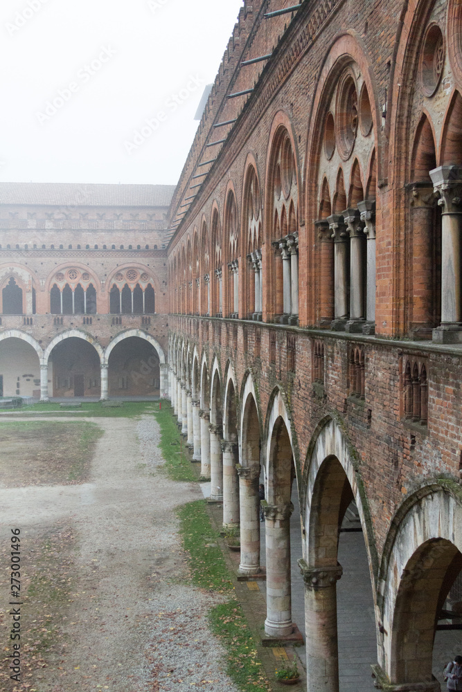 Fototapeta premium Pavia, Italy. November 11 2017. Castello Visconteo (Visconteo castle) on a foggy day.