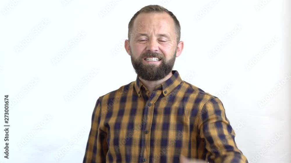 concept of emotions close-up of a bearded man with an angry face in a plaid shirt on a white background expressively showing his fist. concept of emotions close-up of a bearded man with an angry face in a plaid shirt on a white background expressively showing his fist.