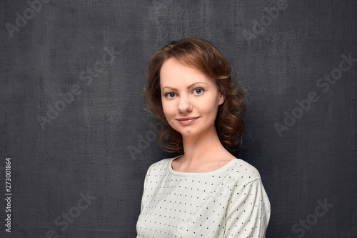 Portrait of cute young woman smiling slightly © Andrei Korzhyts