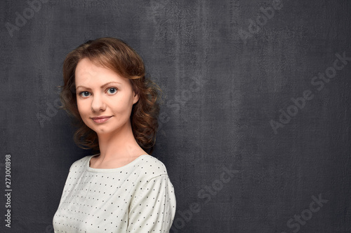 Portrait of cute young woman smiling slightly © Andrei Korzhyts