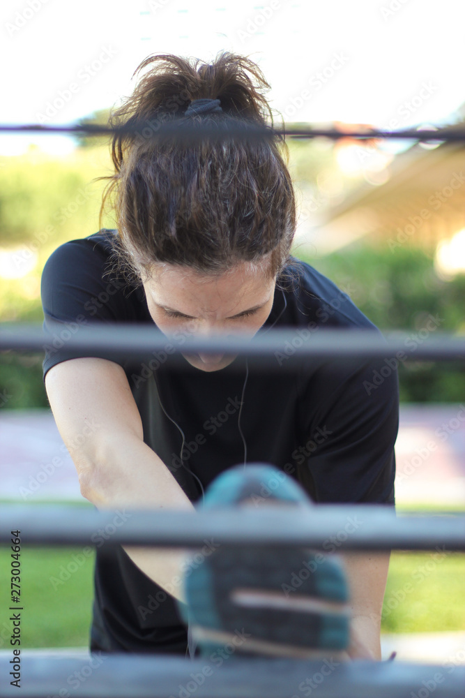 Sporty woman doing stretching exercises before and after training Sporty woman doing stretching exercises before and after training