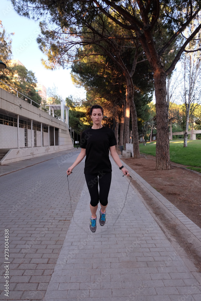 woman working out with jumping rope.