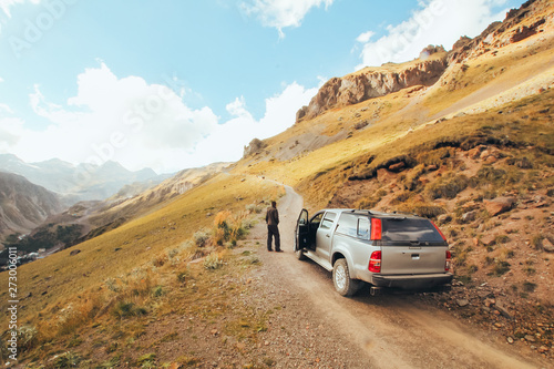 SUV car on a mountain road, autotravel and adventure, beautiful natural landscape. © Ilona