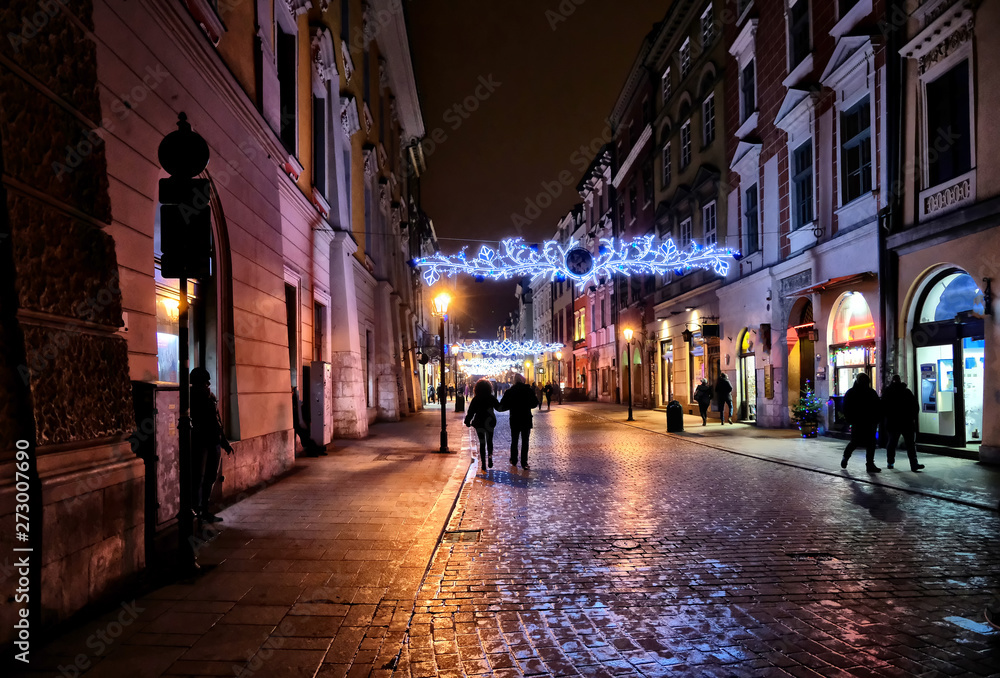 Fototapeta premium Old buildings in the historic district of Krakow at night