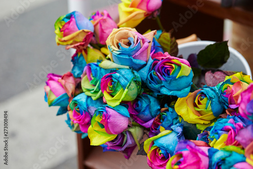 Multi colored dyed roses at flower shop 