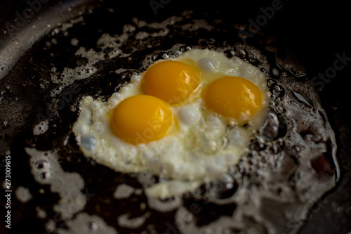 closeup eggs fried in pan