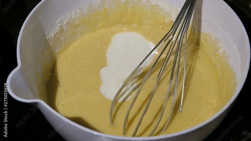 mixing eggs flour and milk in bowl. ingredient to bake pancakes mixing eggs flour and milk in bowl. ingredient to bake pancakes