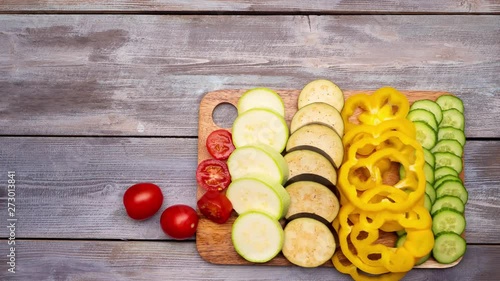 Fresh vegetables. Someone cutting vegetables on the cutting board the takes it away. Stop motion. 4k photo