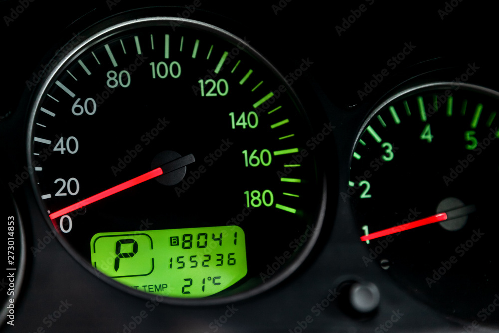 Interior view of car with black salon. Modern luxury prestige car interior: speedometer, dashboard and tachometer with green backlight and other buttons. Soft focus Interior view of car with black salon. Modern luxury prestige car interior: speedometer, dashboard and tachometer with green backlight and other buttons. Soft focus