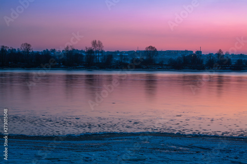 Reflection on the surface of the river at sunset at the beginning of winter, opposite to the settlement the Mariinsky posad