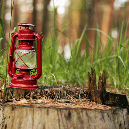 Kerosene lamp in the forest. Abstract photo