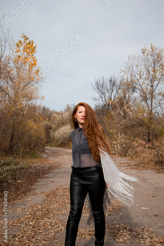 Young redhead woman with scarf in autumn park  © Julia