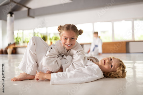Brother and sister feeling happy practicing aikido together photo
