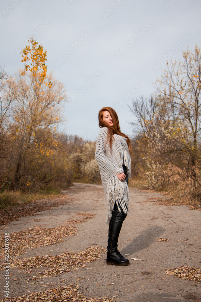 Young redhead woman with scarf in autumn park Young redhead woman with scarf in autumn park
