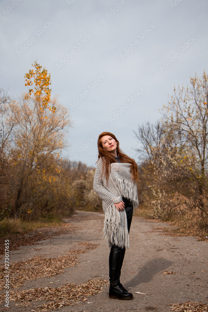 Young redhead woman with scarf in autumn park Young redhead woman with scarf in autumn park