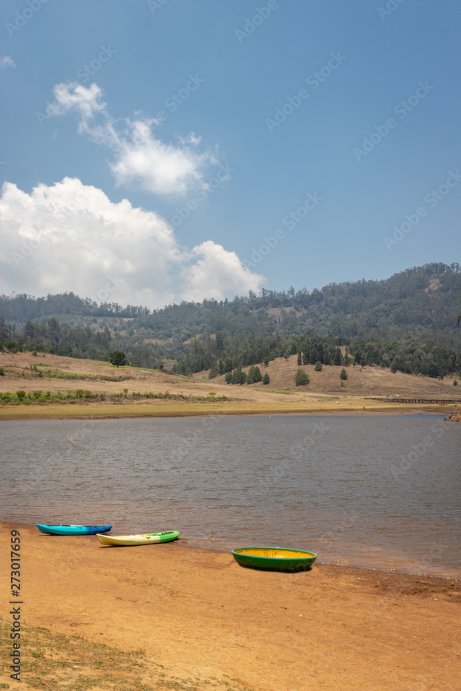 Fototapeta premium kayaking boat at lake shore for water adventure