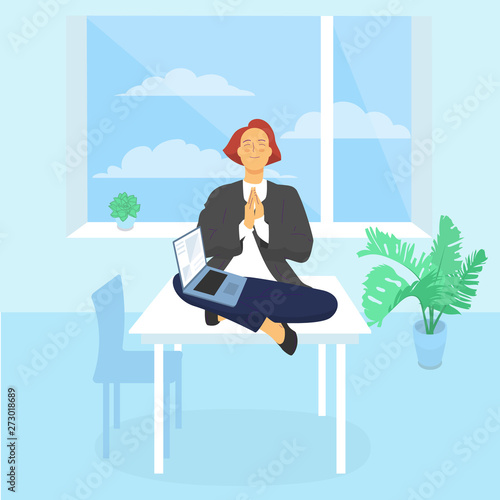 Young female employee is sitting on desk meditating, computer on her lap.