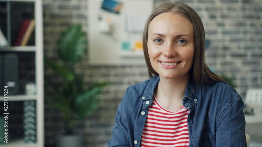 Zoom in portrait of beautiful young lady using laptop at work then smiling looking at camera expressing positive emotions. Attractive people and career concept. Zoom in portrait of beautiful young lady using laptop at work then smiling looking at camera expressing positive emotions. Attractive people and career concept.