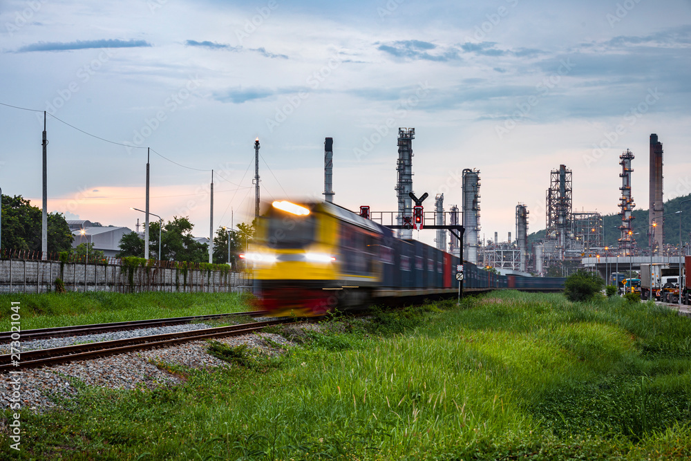 refinery oil and petroleum industry factory zone and containers train  open light movement foreground with background sky in the rain season