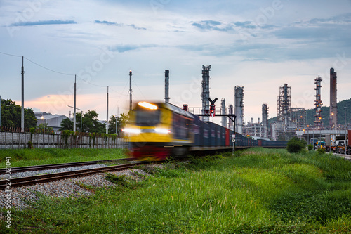 refinery oil and petroleum industry factory zone and containers train open light movement foreground with background sky in the rain season